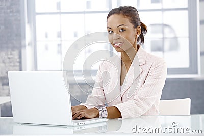 Afro businesswoman using laptop Stock Photo