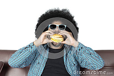 Afro man eating yummy hamburger Stock Photo