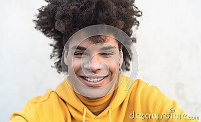 Afro smiling man portrait - Mixed race young guy with curly hair posing in front camera Stock Photo