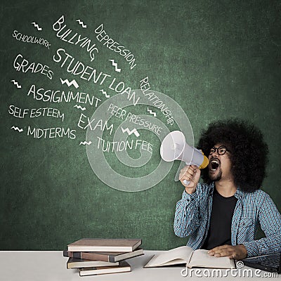 Afro student looks angry with his problems Stock Photo