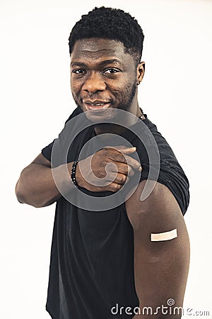 Afroamerican men showing vaccine straightforward white background - portrait shot Stock Photo