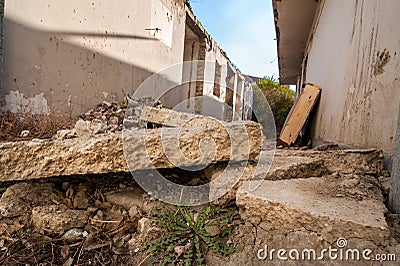 Aftermath remains of hurricane or earthquake disaster damage on ruined old house with collapsed roof and brick walls selective foc Stock Photo