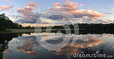 Afternoon clouds reflected in still water Stock Photo