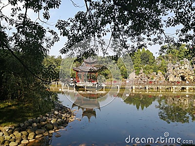 The afternoon of the park, the sunlight is very quiet, the water in the lake bottom, the mirror lake pavilion and plants Editorial Stock Photo