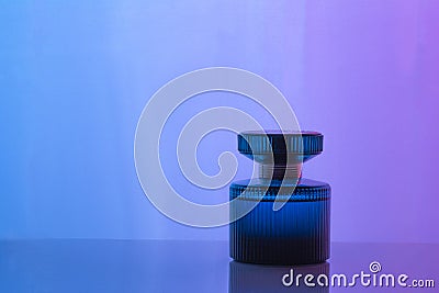 Aftershave, cologne, perfume bottle set on dark purple background with reflection. Women`s perfume Stock Photo