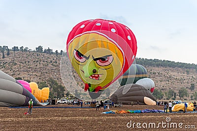 The maintenance team inflate the hot air balloons on the ground before the flight at the hot air balloon festival Editorial Stock Photo