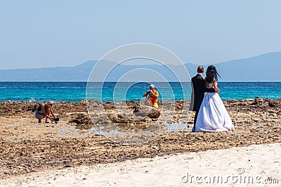 Photographing newlyweds on the beach in Halkidiki, Greece Editorial Stock Photo