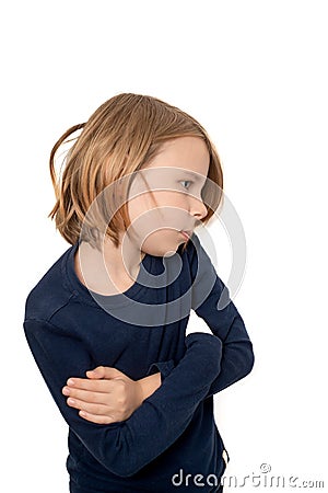 Against a backdrop of pristine white, a contemplative ten-year-old boy exudes a subdued sense of wistfulness Stock Photo