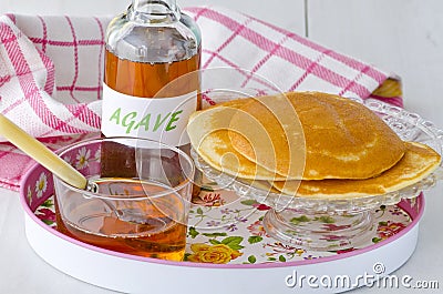 Agave syrup and a plate of pancakes. Stock Photo