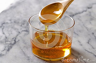 Agave syrup pouring on a glass. Stock Photo