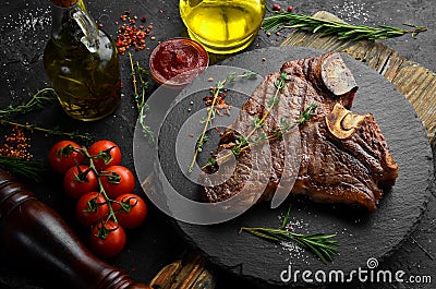 Aged Beef T-Bone steak. Juicy cooked steak with rosemary and spices. Stock Photo