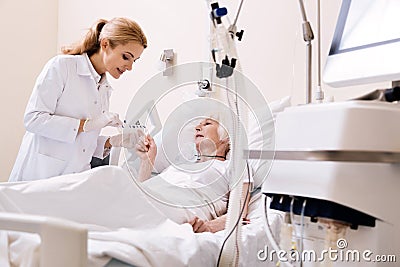 Aged bright woman specifying some details of her treatment Stock Photo