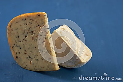 Aged cheddar and Camembert on blue Stock Photo