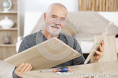 aged contractor repairman working in kitchen Stock Photo