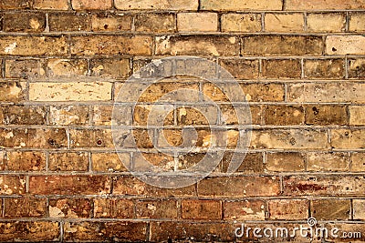 Aged partially crumbled brown brick wall background Stock Photo