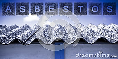 Aged dangerous asbestos roof made of prefabricated corrugated panels with asbestos text Stock Photo