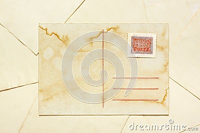 Aged empty postcard with painted abstract postage stamp Stock Photo