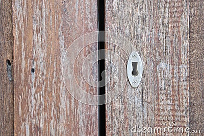 Aged old key hole on opened wooden door Stock Photo