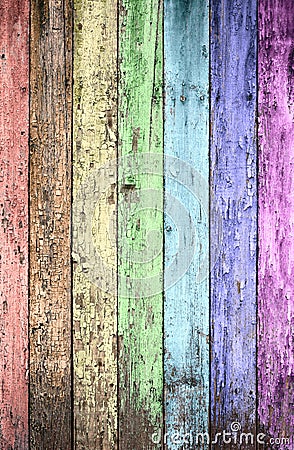 Aged rainbow painted wooden fence Stock Photo