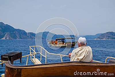 An aged senior man on a luxurious yacht boat looking at the blue sea. ocean vacation transport. marine boat trip. rich Editorial Stock Photo