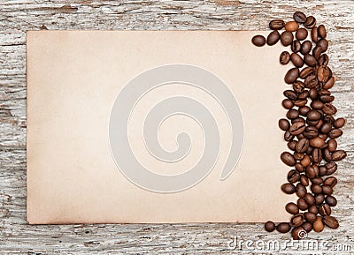 Aged sheet of paper with coffee beans on the old wood Stock Photo
