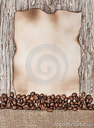 Aged sheet of paper with coffee beans on the old wood Stock Photo