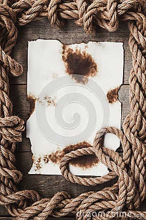 Aged sheet of paper and rope Stock Photo