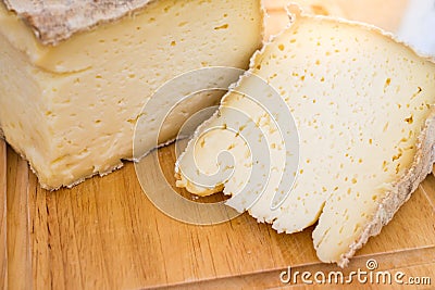 Aged soft cheese on a served on wooden background. Dairy delicacies. Stock Photo