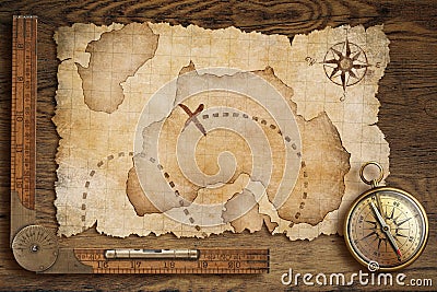 Aged treasure map, ruler and old bronze compass on table Stock Photo