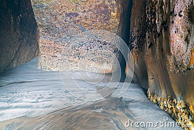 Aged weather and sea worn rock cave walls Stock Photo