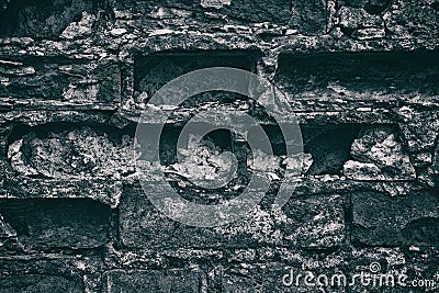 Gloomy dark background of weathered gray brick wall close-up Stock Photo