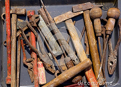 Aged weathered rusty hand tools in black Stock Photo