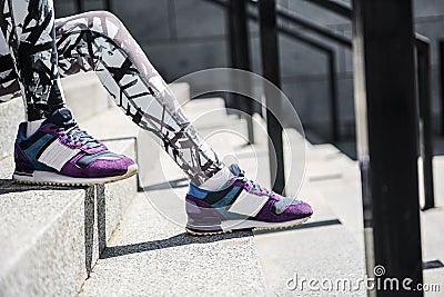 Aged woman having break time on city stairs with handrails Stock Photo