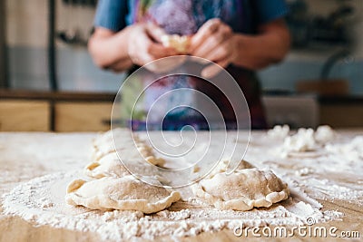 Aged woman preparing cookies filled with cottage cheese Stock Photo