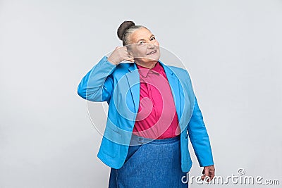 Aged woman showing call center sign Stock Photo