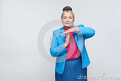 Aged woman showing time out sign Stock Photo