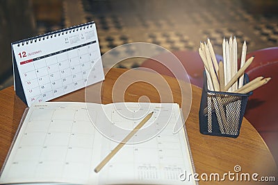 Agenda, planner book, calendar, and pencil place on office desk. Diary for organizer to plan timetable, daily appointment, and Stock Photo