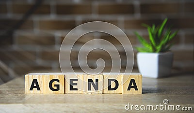AGENDA word made with building blocks on brick background. Stock Photo