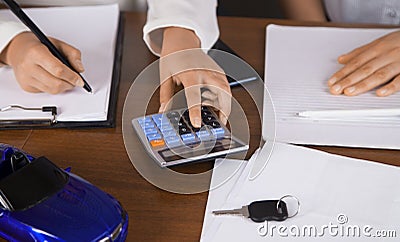 Agent car salesman informs about the car purchase contract. Two women Stock Photo