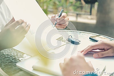 Agent shows car insurance to lender. salesman dealer presenting purchase order contract to customer Stock Photo