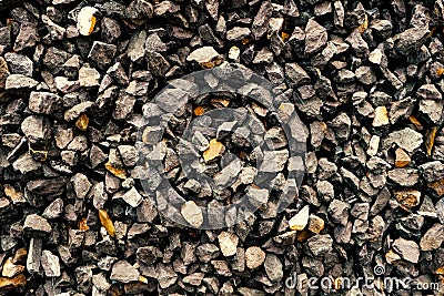 Aggregate of coarse dark grey stones creating a gravel / grit pattern Stock Photo