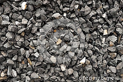 Aggregate of dark gray and coarse stones crushed at a stone pit - gravel pattern Stock Photo