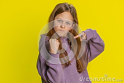 Aggressive angry child girl trying to fight at camera, shaking fist, boxing, punishment, threaten Stock Photo