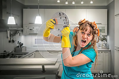 Aggressive housewife woman washing dishes in kitchen Stock Photo