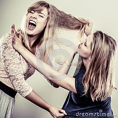 Aggressive mad women fighting each other. Stock Photo