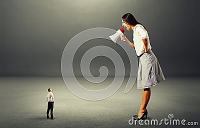 Aggressive woman screaming at small man Stock Photo