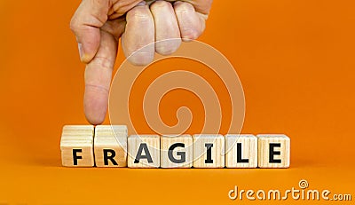 Agile or fragile symbol. Concept words Agile and Fragile on wooden cubes. Beautiful orange table orange background. Businessman Stock Photo