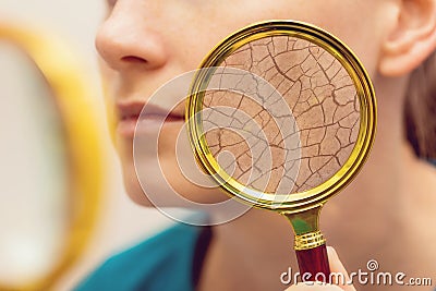 Aging and dry face skin concept - woman with magnifying glass Stock Photo