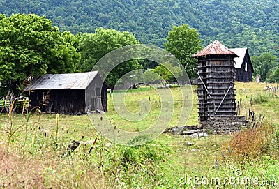 Aging Farm With Octagon Shaped Wooden Silo Stock Photo