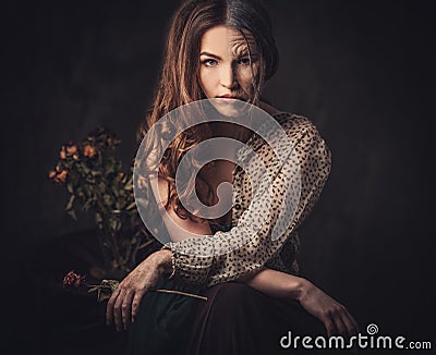 Aging, skin care concept. Half old half young woman with faded rose bouquet. Stock Photo